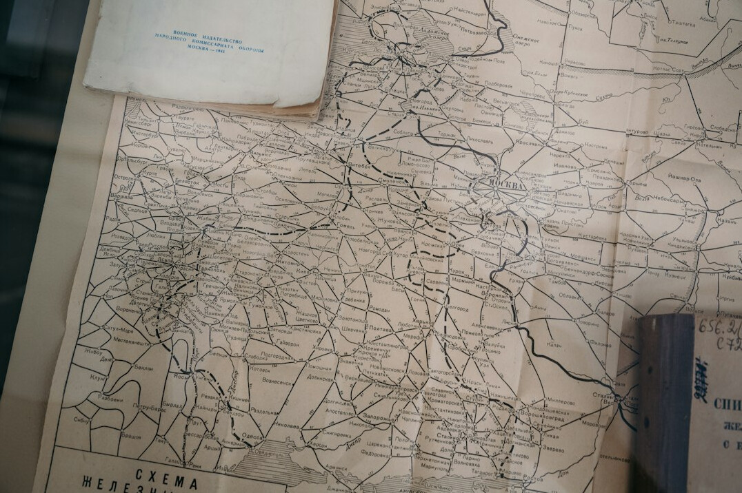 Vintage compass and historic map on wooden table