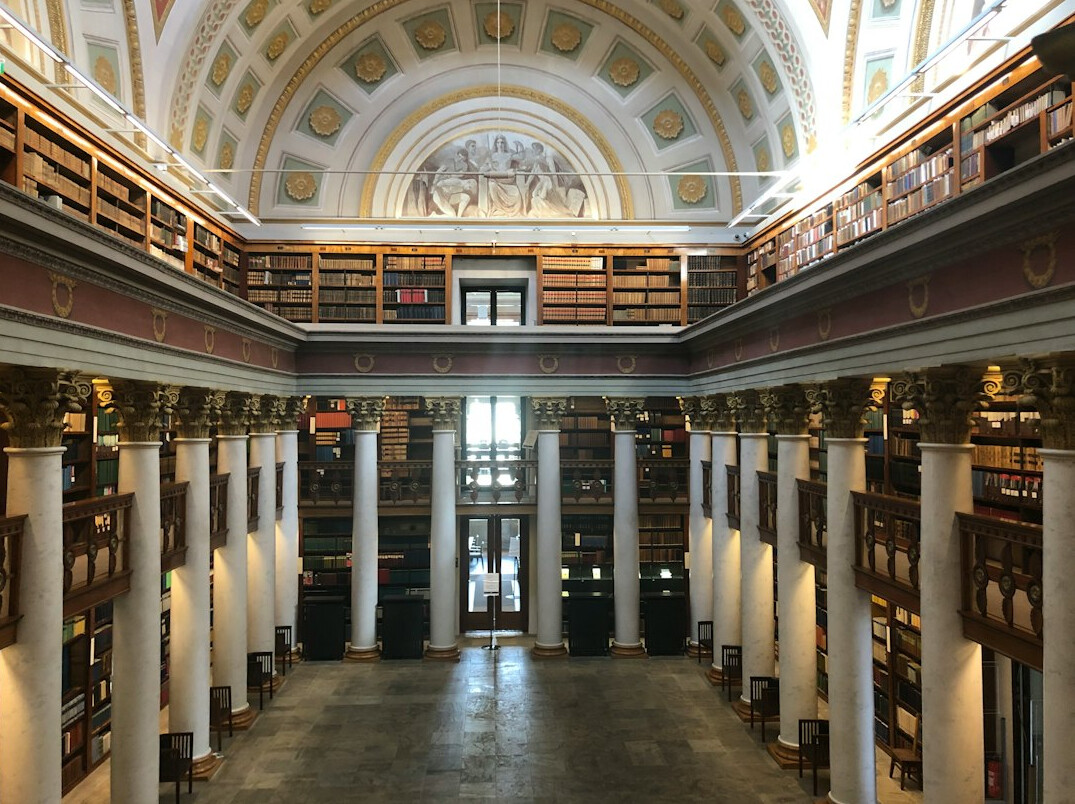 Interior of a grand historical library with tall shelves